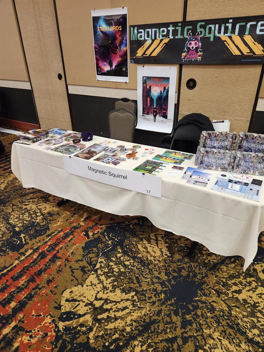 Magnetic Squirrel table at SaltCon 2024 &mdash; Star Lords and Zombie Apocalypse posters